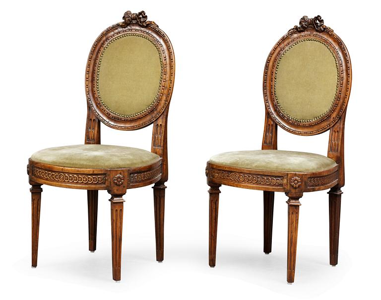 A pair of Louis XVI chairs.