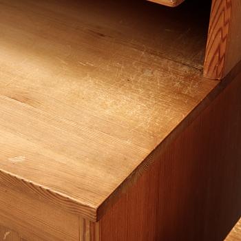 A pair of pine cupboards with shelves by Carl Malmsten.