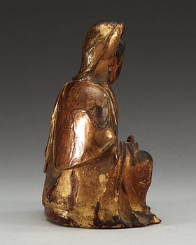 A gilt lacquer and wooden sitting figure of Guanyin, Ming dynasty (1368-1644).