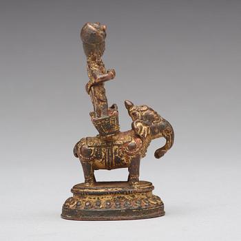 A gilt bronze figure of a deity on an elephant, presumably Nepal, 15th Century.