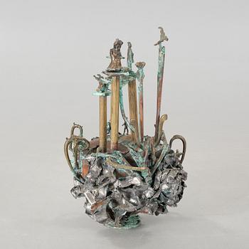 a metal sculpture, signed and dated 1980.