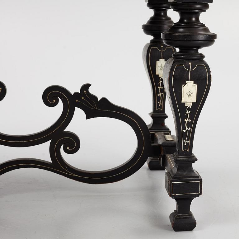 A Renaissance-style ebony, ebonized and ivory-inlaid library table, late 19th century, presumably Germany.