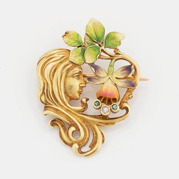 497. An 18K gold and enamel brooch set with an old-cut diamond and green stones.