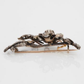 A BROOCH set with old-cut diamonds.