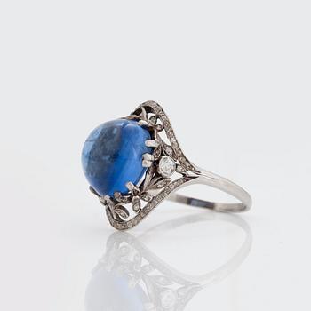 A RING set with a cabochon-cut sapphire.