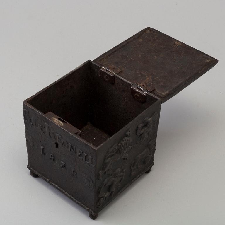 An empire cast iron tobacco box, dated 1838.