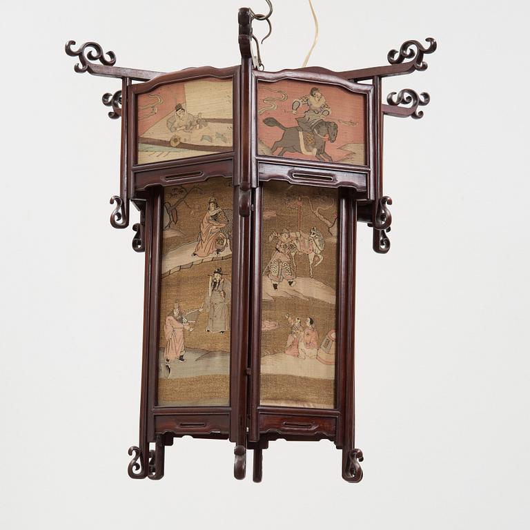 A lantern with panels of kesi woven silk, Qing dynasty, circa 1900.