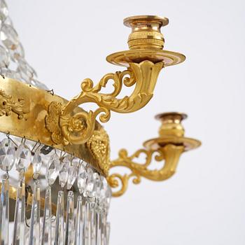 An French Empire eight-light gilt-brass and cut-glass chandelier.