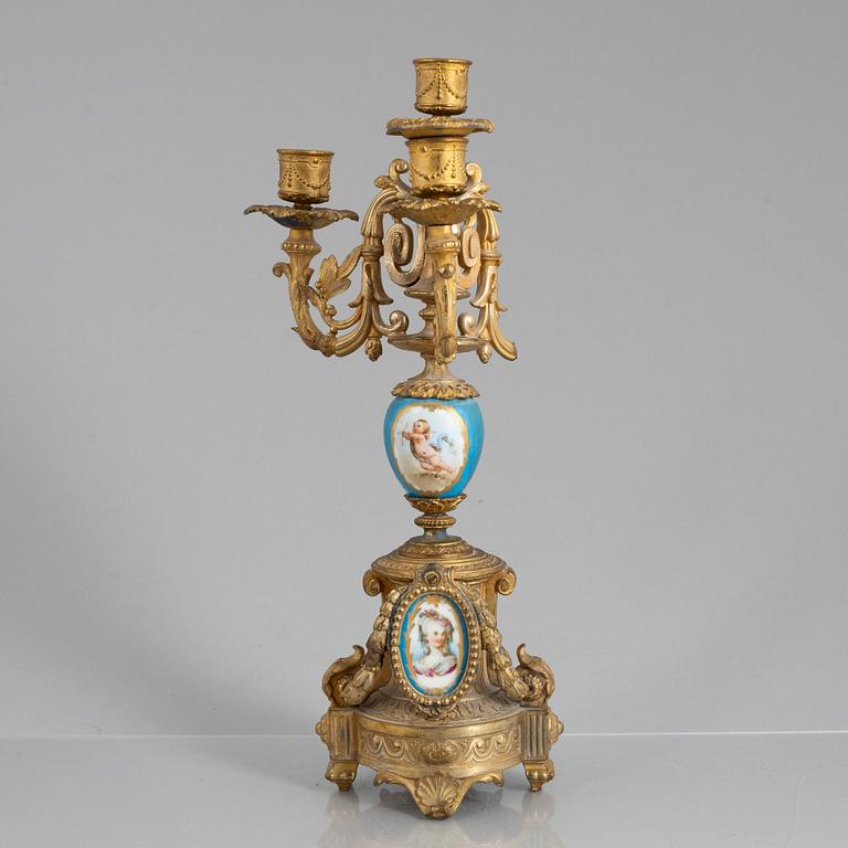 A Louis XVI style mantel clock and a pair of candelabra, circa 1900.