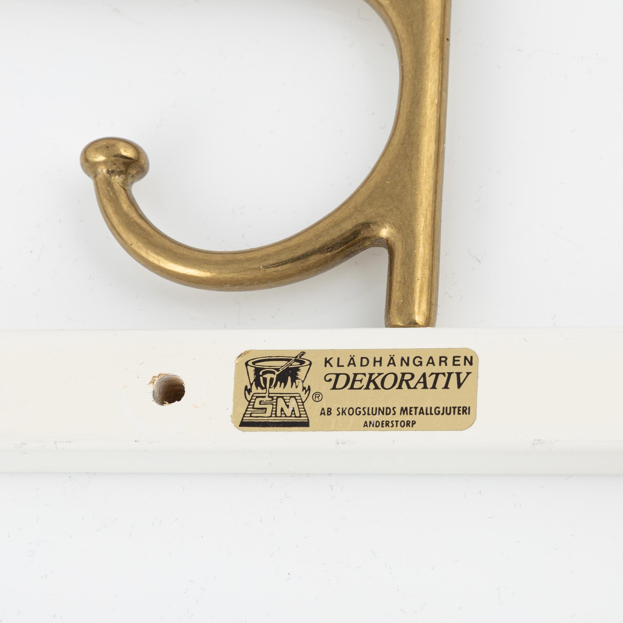 A pair of 'Dekorativ' coat hangers, Skoglunds metallgjuteri, Anderstorp, mid 20th Century.