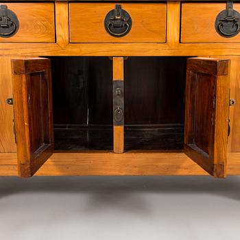 A Chinese elmwood sideboard, from around the turn of the century 1900.