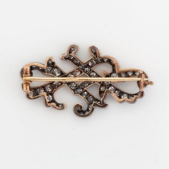 A gold and silver brooch set with old- and rose-cut diamonds.