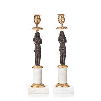 85. A pair of late Gustavian circa 1800 white marble and bronze candlesticks.