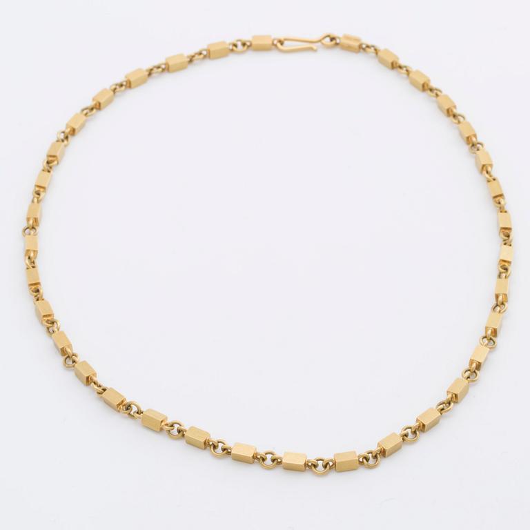 WIWEN NILSSON COLLIER 18K guld mindre stavar och ringar, Lund 1970, original etui.