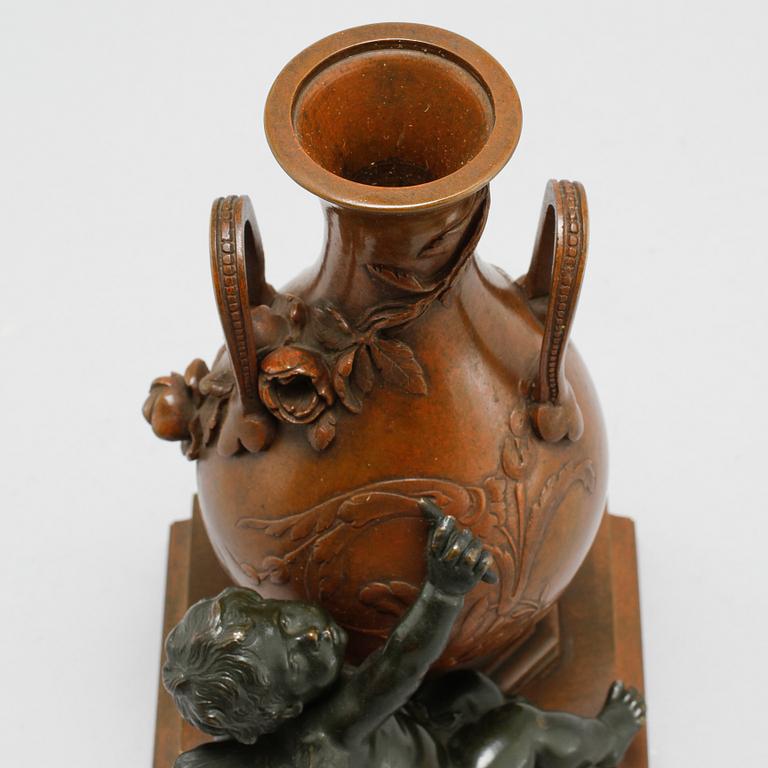 A patinated bronze vase after Auguste Moreau, made around year 1900.