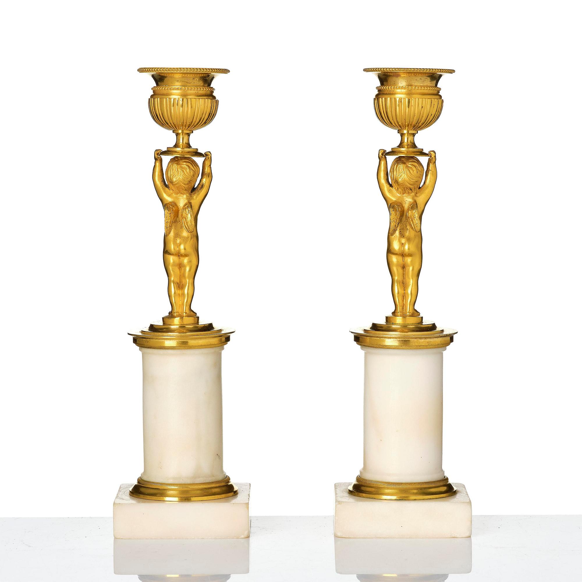 A pair of late Gustavian white marble and ormula candlesticks.