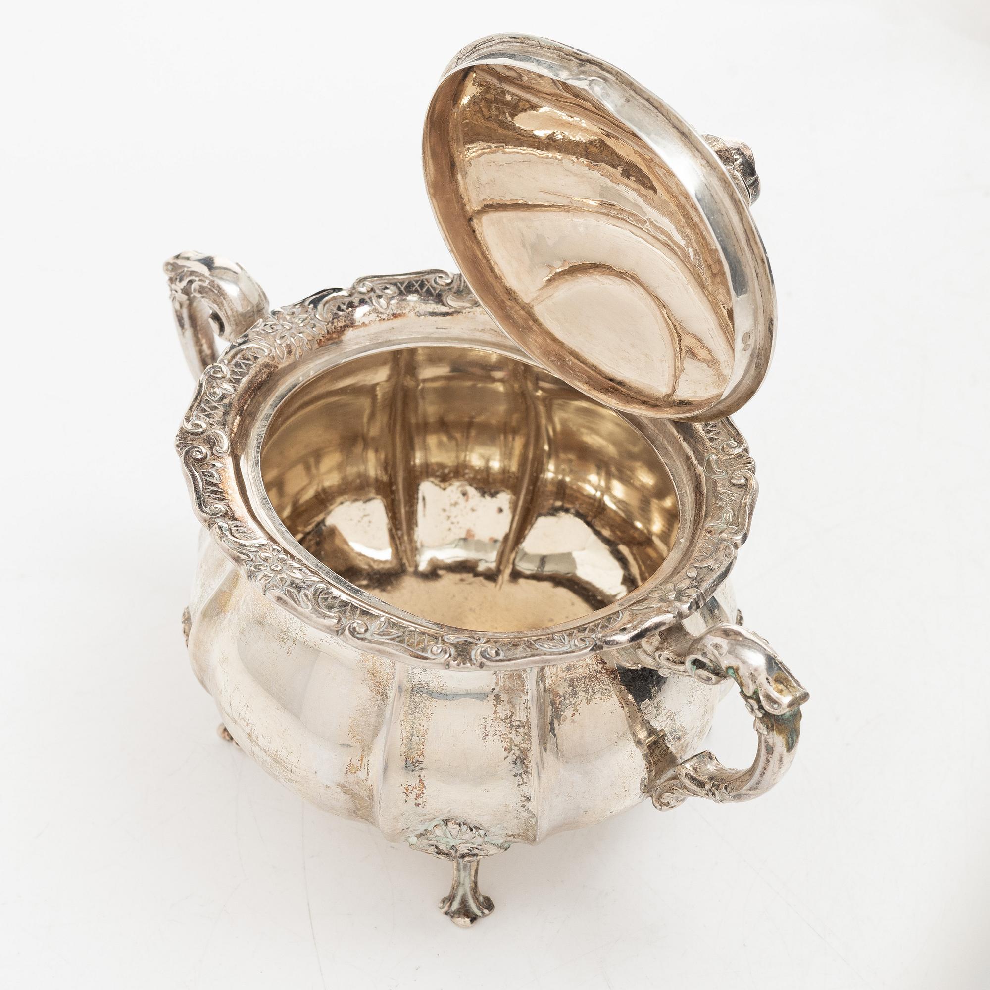 A Rococo style silver coffee pot, cream jug and sugar bowl, 20th century, Swedish import mark.