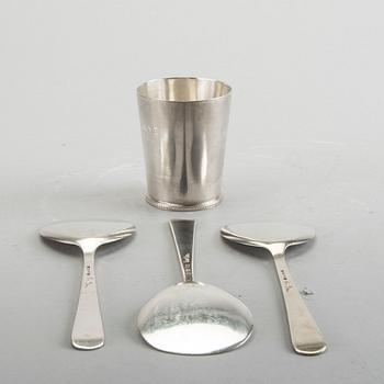 A Swedish 20th century sterling set of three sandwich spoons ad a beaker mark of W Nilsson Lund 1965, 1967 and 1946,