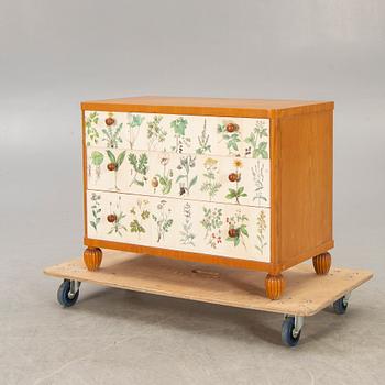 A 1940s elm chest of drawers.