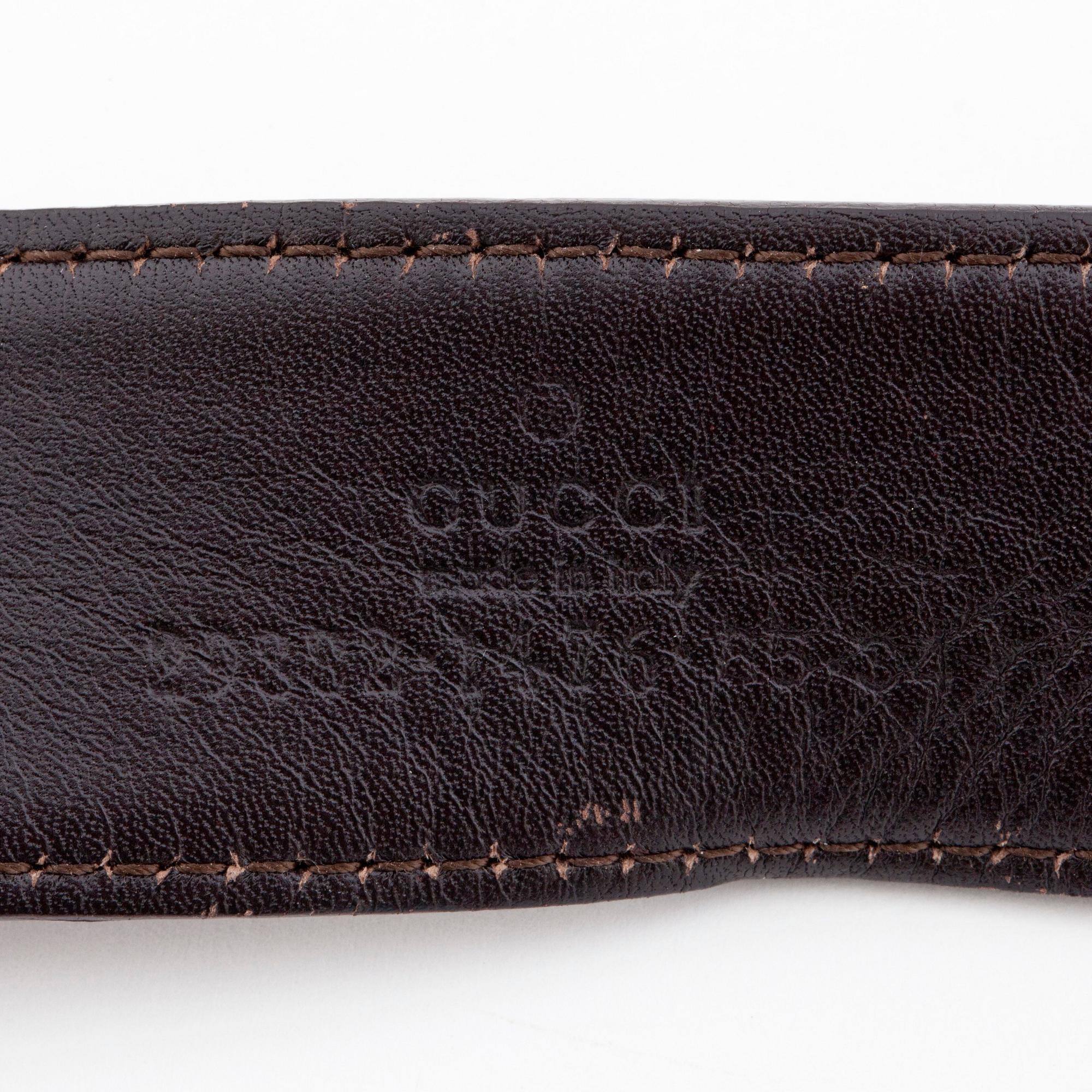 GUCCI, a striped belt.