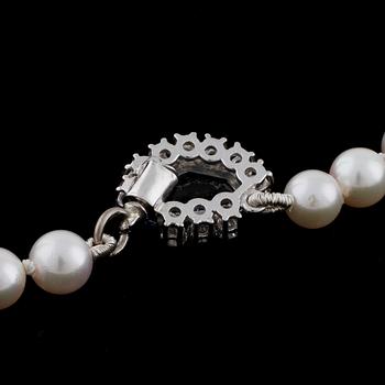 A cultured pearl necklace with a sapphire and diamond clasp.