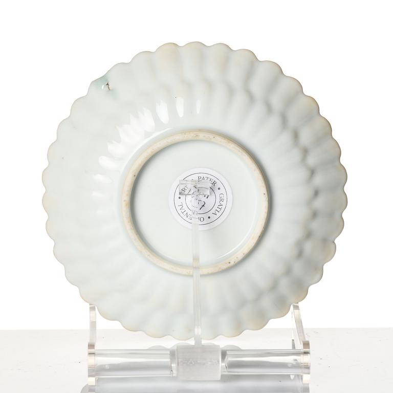 A Chinese iron red porcelain cup with saucer and a small famille verte dish, Qing dynasty, Kangxi (1662-1722).