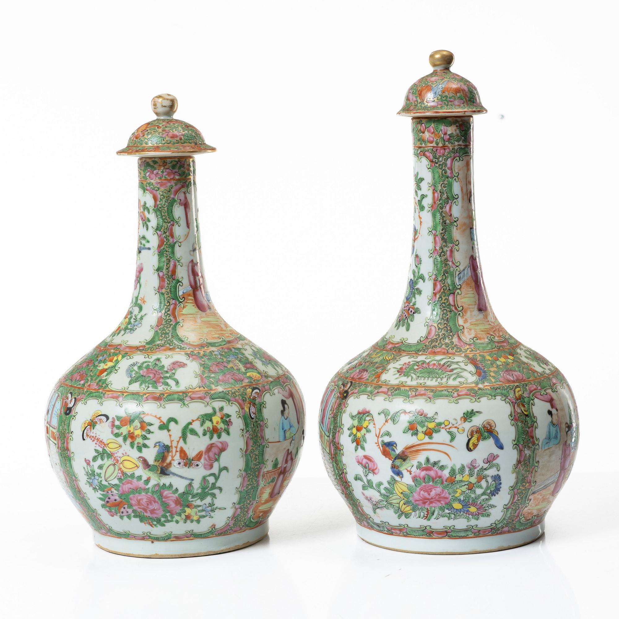 Two famille rose 'Canton' vases with covers, Qing dynasty, 19th century.