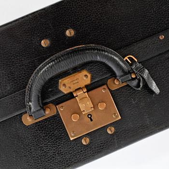 HERMÈS, a black leather suitcase from the 1950/60s.