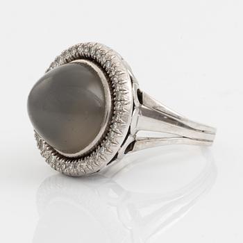 A cabochon cut grey moonstone and diamond ring.