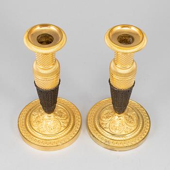 A pair of empire, ormolu candlesticks, first half of the 19th century.