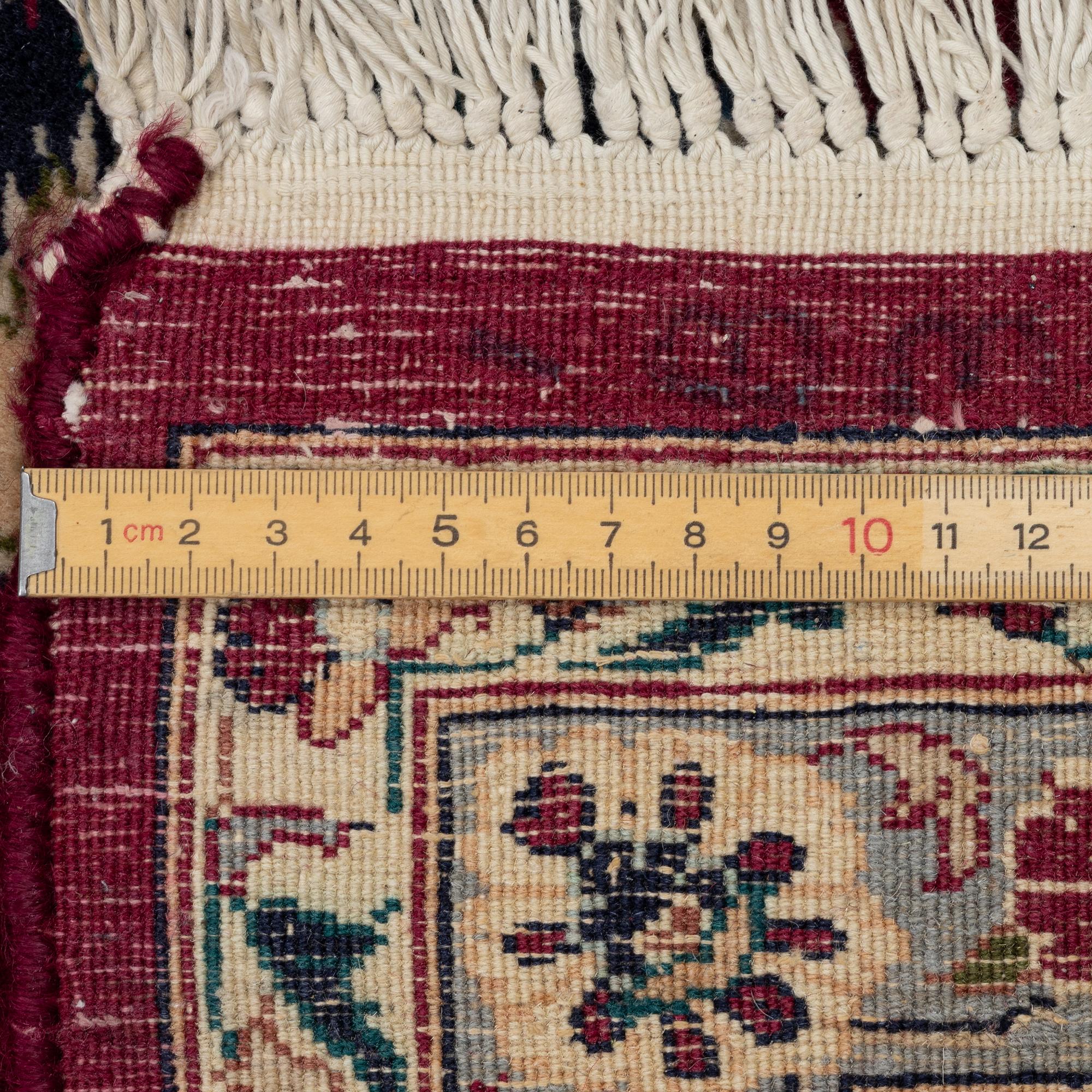 An oriental carpet, a. 378 x 278 cm.