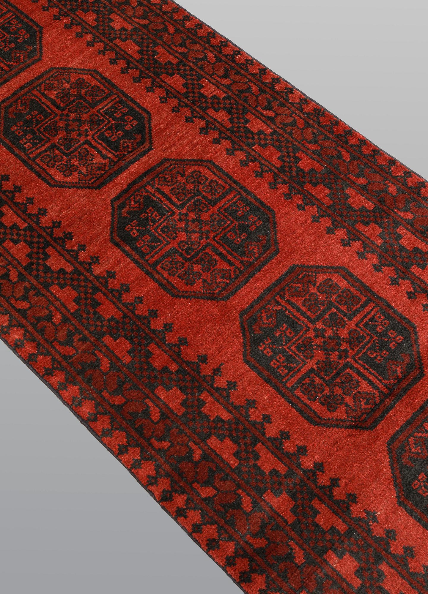 An Afghan runner, ca 383 x 78 cm.