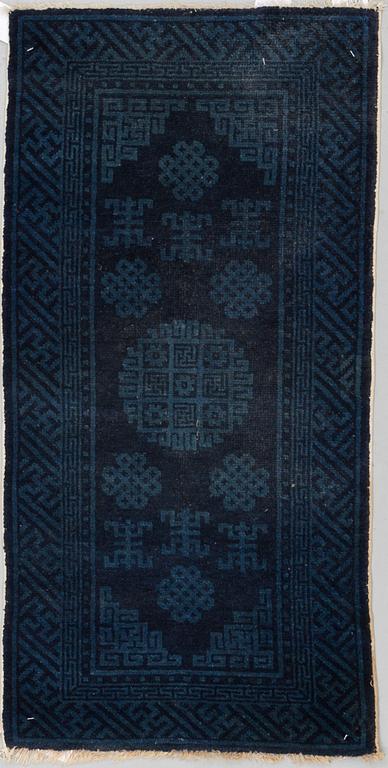 A RUG, a semi-antique Baotou, ca 108 x 54,5 cm.