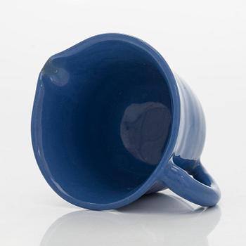 Marita Lybeck, a set of three ceramic plates and cream jug, red clay, signed ML.