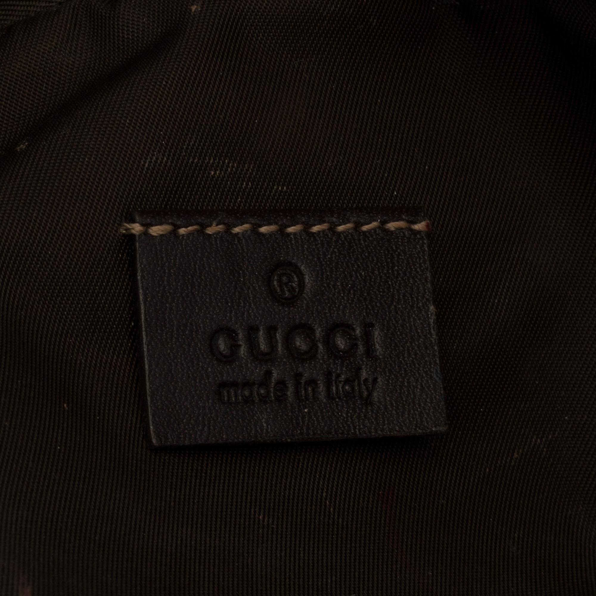 GUCCI, a monogram beauty bag.