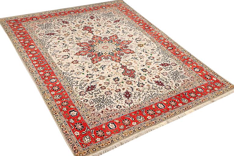 A Tabriz, part silk carpet, c. 300 x 199 cm.