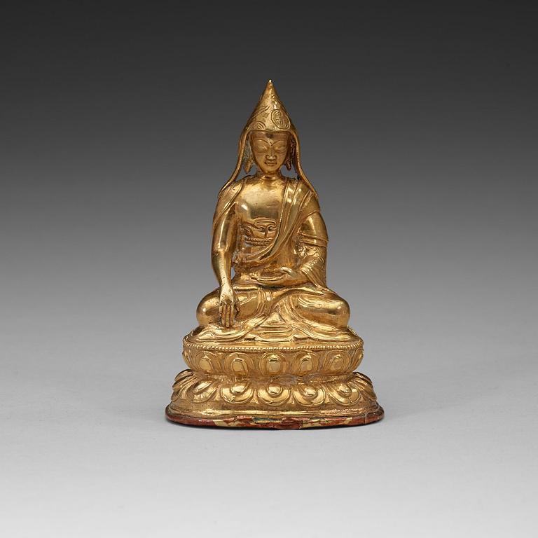 A Tibetan copper alloy figure of a Lama, circa 1900.