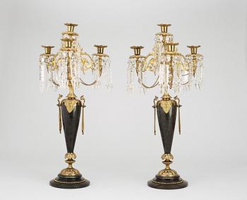 A pair of late 19th century black marble and gilt bronze kandelabra.