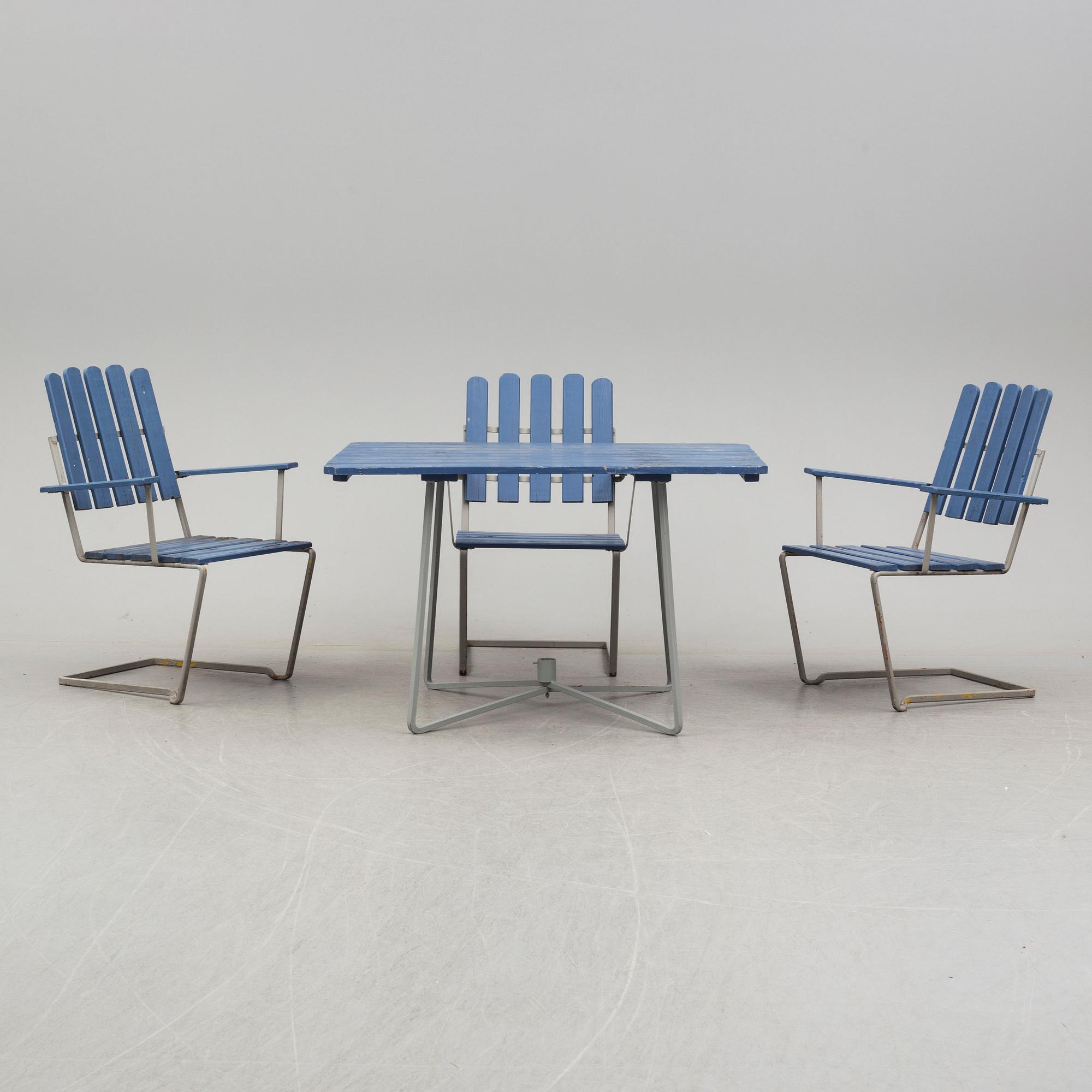 A painted garden table and four armchairs, first half of the 20th century.