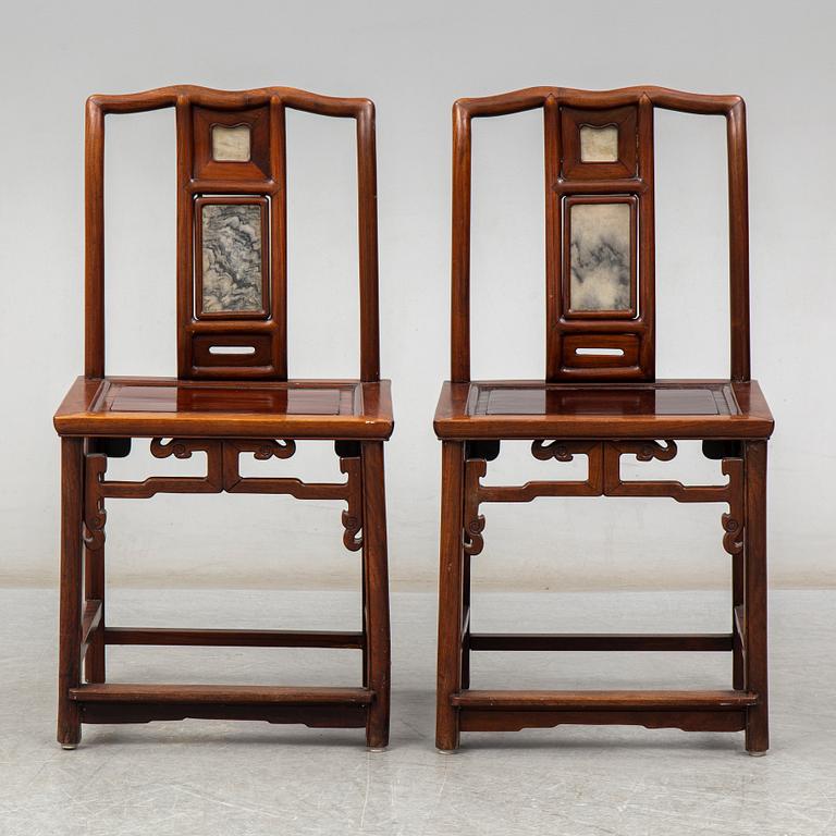 A pair of Chinese hardwood armchairs, early 20th century.