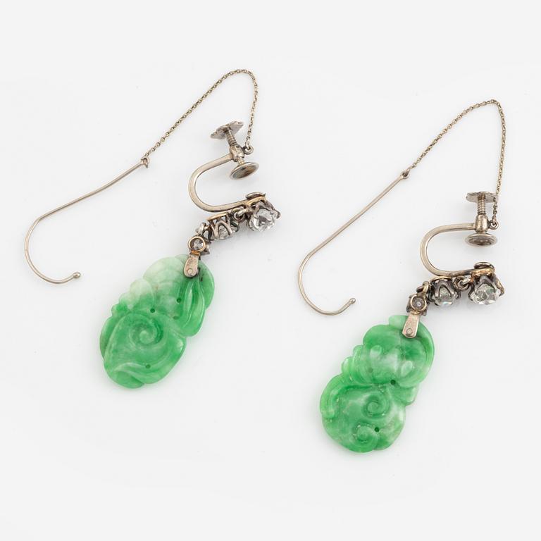 A pair of 18K white gold earrings with carved jadeite set with old-cut diamonds.