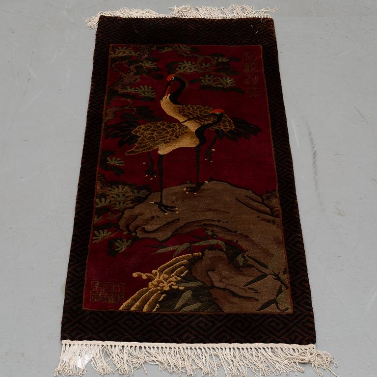 A RUG, silk China, ca 124 x 47 cm.