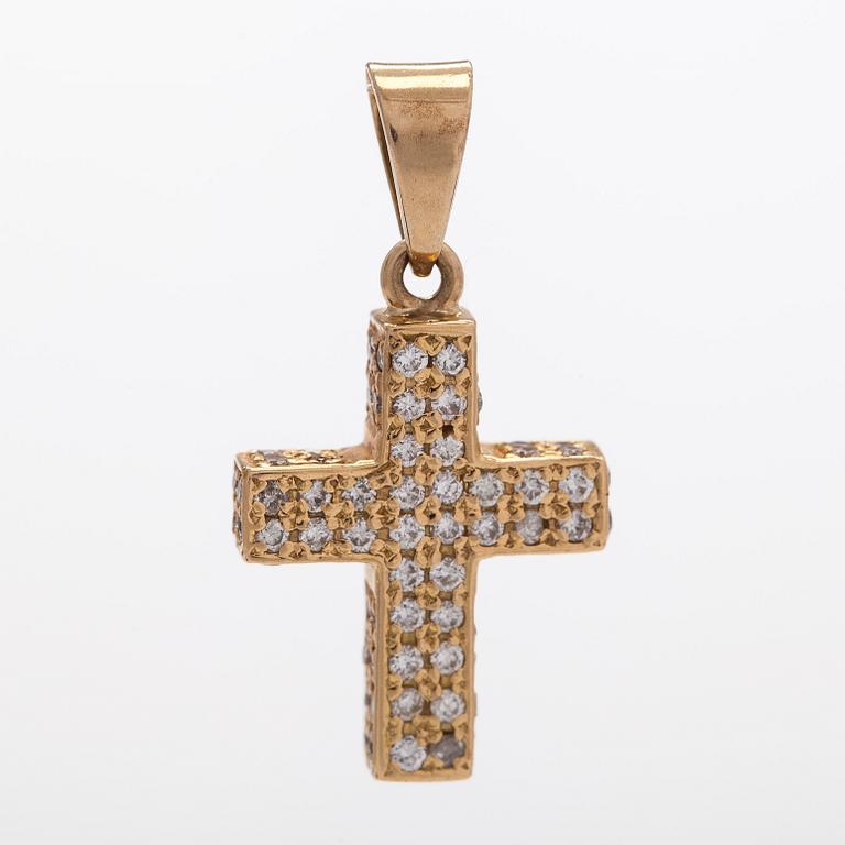 A 14K gold cross pendant with diamonds.