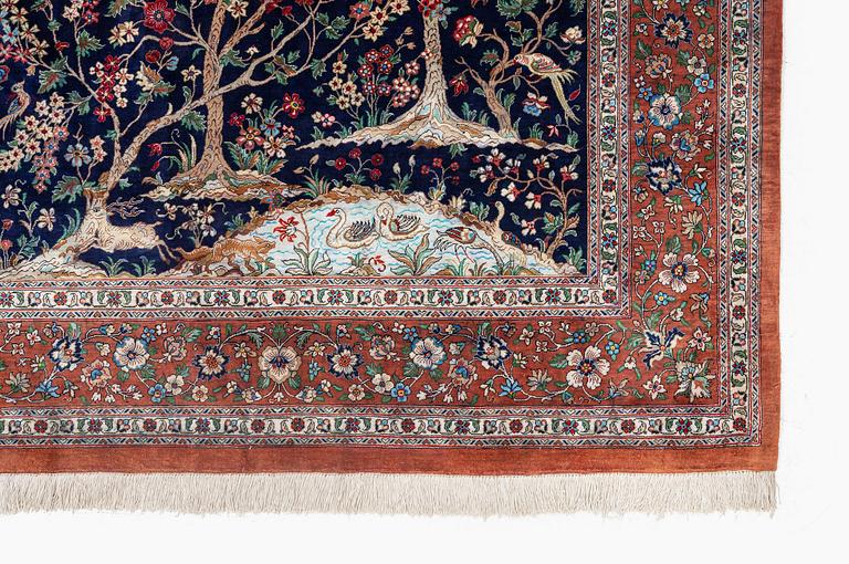 A signed pictoral silk Qum rug, c. 203 x 127 cm.