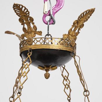 A presumably Russian Empire gilt and patinated bronze nine-branch chandelier, 19th century.