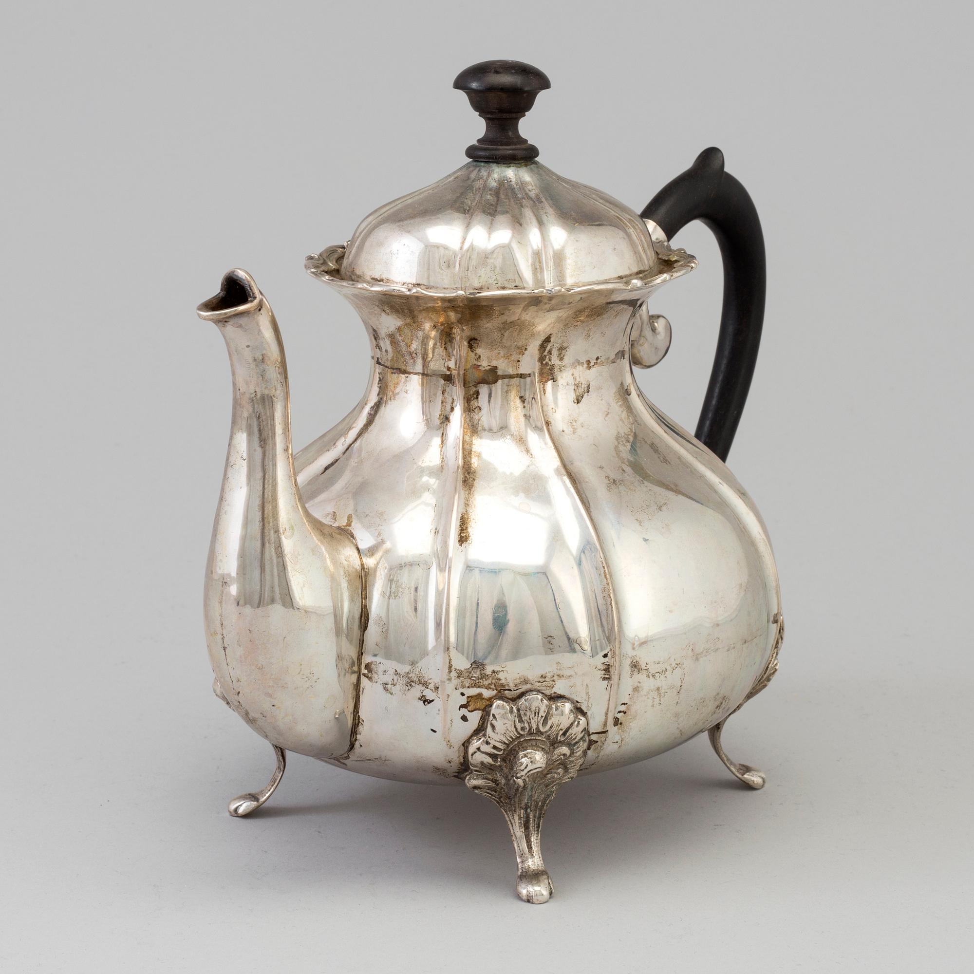 A silver rococo style teapot.