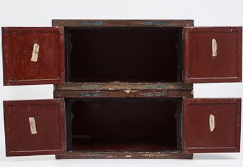 A lacquered cabinet, in two sections, Qing dynasty, 19th Century.