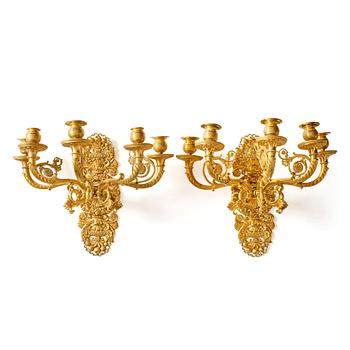 119. A pair of French Empire ormolu five-branch wall-lights, Paris, early 19th century.