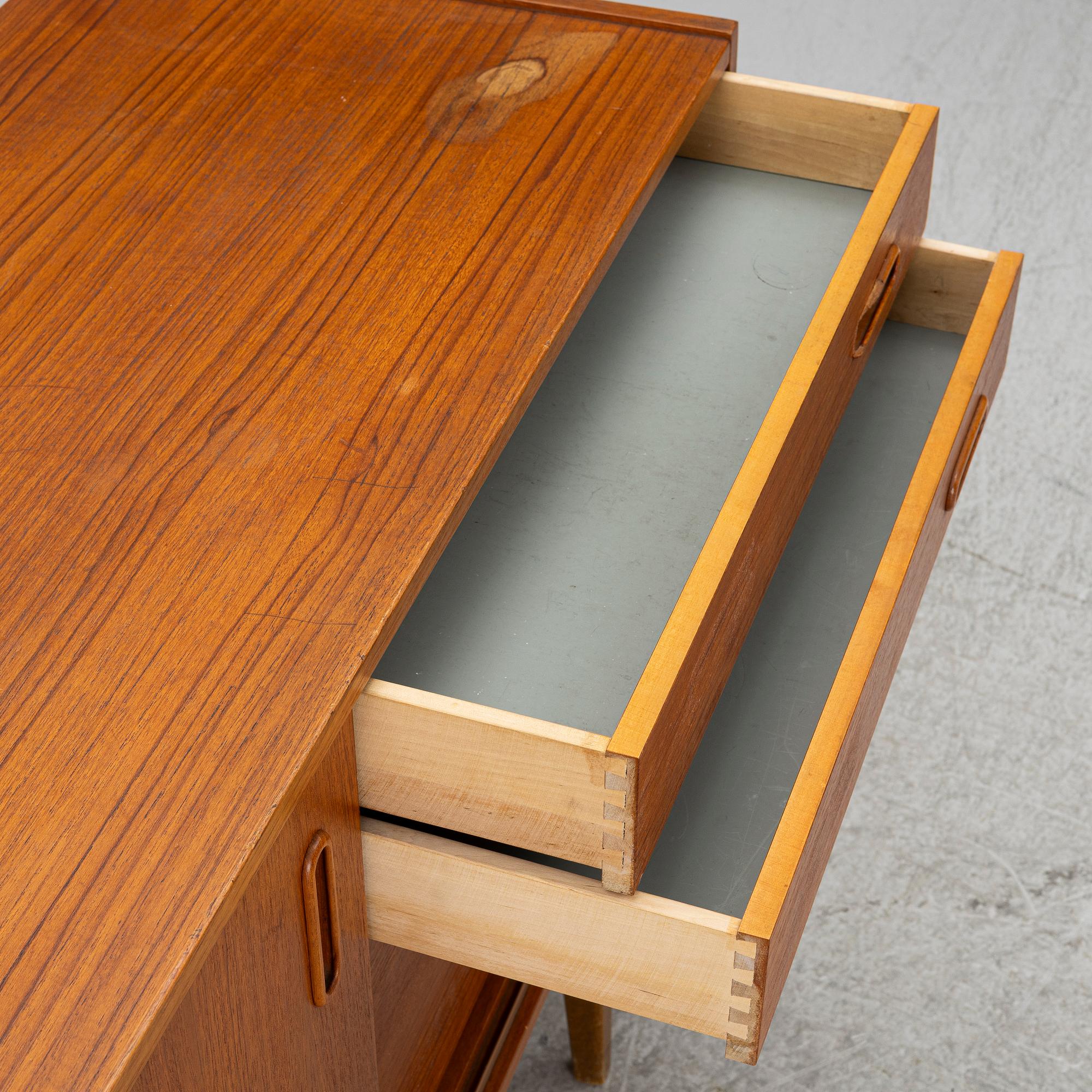 A 1950's teak veneered sideboard.