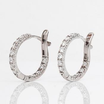 A pair of diamond earrings.